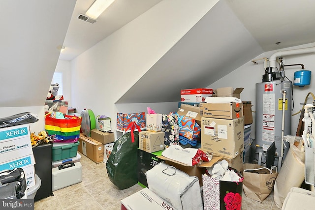 interior space with visible vents and gas water heater