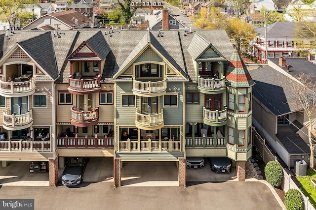 exterior space featuring a residential view and roof with shingles