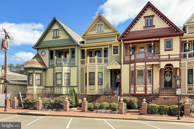 victorian home featuring uncovered parking