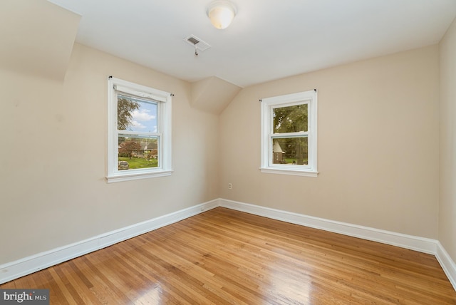 additional living space featuring baseboards, visible vents, and light wood-style floors