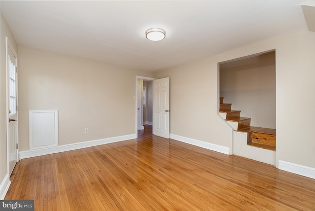 interior space featuring baseboards, light wood-style floors, and stairway