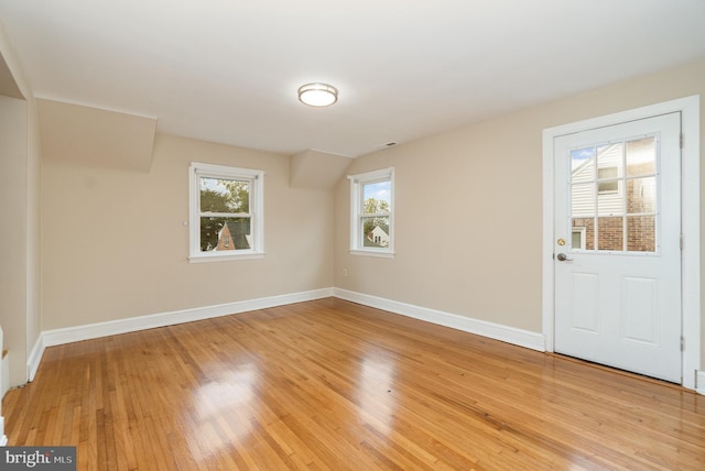 unfurnished room featuring baseboards and light wood-type flooring