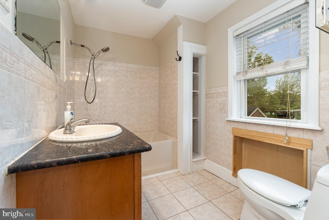 bathroom featuring tile walls, toilet, vanity, shower / bathing tub combination, and tile patterned flooring
