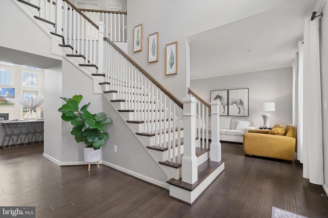 4379 Shamrock Dr, Monrovia, MD 21770 - stairs featuring wood finished floors, a towering ceiling, baseboards, and ornamental molding