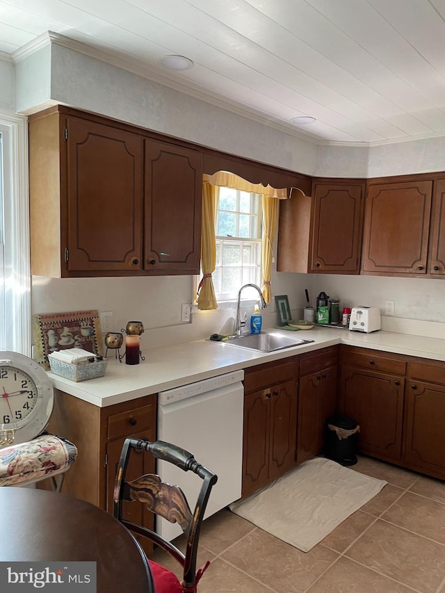 kitchen with light countertops, white dishwasher, a sink, and ornamental molding