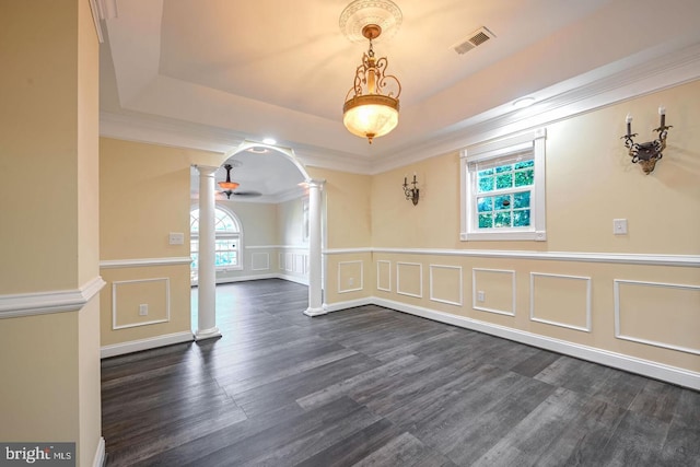 6411 L St, Capitol Heights, MD 20743 - unfurnished dining area featuring decorative columns, a decorative wall, plenty of natural light, a tray ceiling, and dark wood finished floors