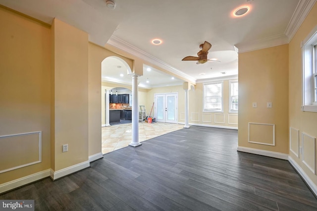 6411 L St, Capitol Heights, MD 20743 - empty room with ornate columns, crown molding, a ceiling fan, arched walkways, and dark wood-style floors