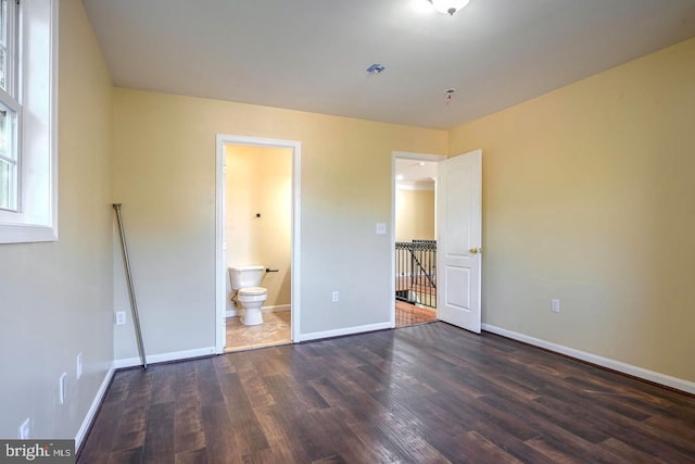 6411 L St, Capitol Heights, MD 20743 - unfurnished bedroom featuring wood finished floors, baseboards, and ensuite bathroom