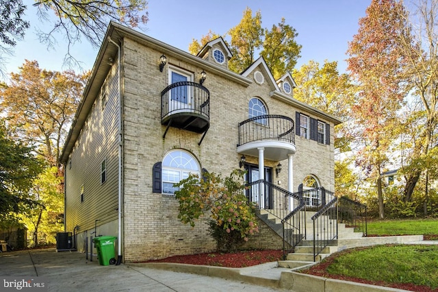 6411 L St, Capitol Heights, MD 20743 - view of front facade with a balcony, central AC, and brick siding