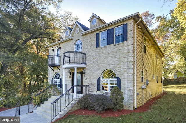 6411 L St, Capitol Heights, MD 20743 - view of front facade featuring a balcony and a front lawn