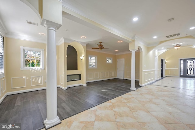 6411 L St, Capitol Heights, MD 20743 - entryway featuring decorative columns, ceiling fan, a decorative wall, ornamental molding, and a glass covered fireplace