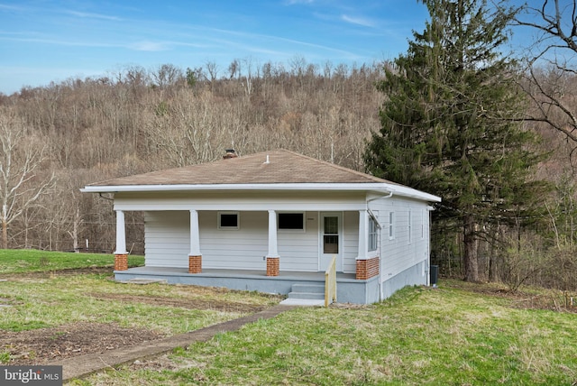 20524 Sunlight Dr SW, Lonaconing, MD 21539 - exterior space featuring central AC unit, a chimney, a front lawn, covered porch, and a shingled roof