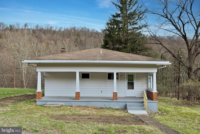 20524 Sunlight Dr SW, Lonaconing, MD 21539 - view of front of property featuring a front lawn, a porch, and a view of trees