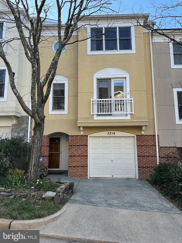 3814 Woodlawn Ct, Alexandria, VA 22304 - view of front of property featuring brick siding, a garage, stucco siding, and driveway