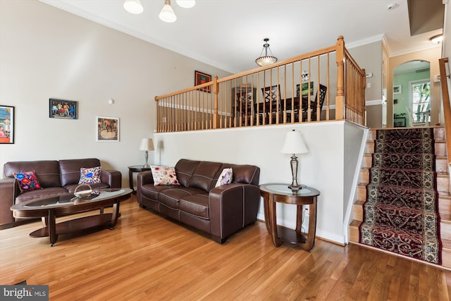 3814 Woodlawn Ct, Alexandria, VA 22304 - living area with crown molding, arched walkways, stairs, and wood finished floors