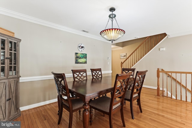 3814 Woodlawn Ct, Alexandria, VA 22304 - dining space featuring visible vents, baseboards, light wood finished floors, ornamental molding, and stairs