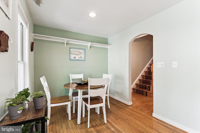 3814 Woodlawn Ct, Alexandria, VA 22304 - dining area with arched walkways, recessed lighting, baseboards, light wood-type flooring, and stairway