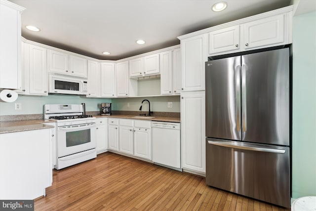 3814 Woodlawn Ct, Alexandria, VA 22304 - kitchen featuring a sink, white appliances, light wood-style flooring, white cabinetry, and recessed lighting