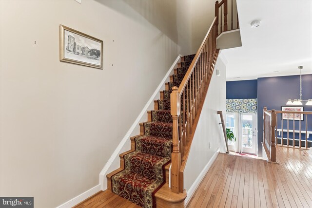 3814 Woodlawn Ct, Alexandria, VA 22304 - stairway featuring baseboards, hardwood / wood-style flooring, and a towering ceiling