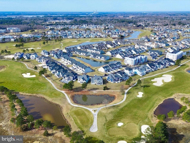 drone / aerial view featuring a residential view, golf course view, and a water view