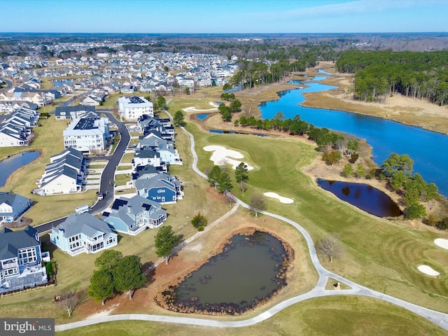 drone / aerial view featuring a residential view, golf course view, and a water view