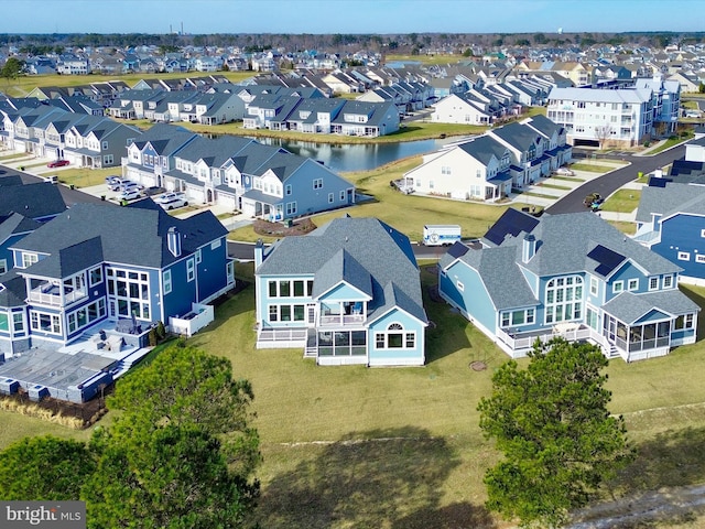 drone / aerial view with a residential view and a water view