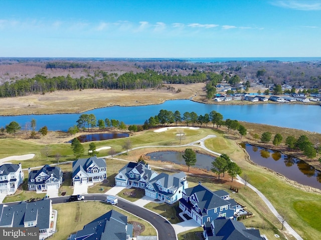 birds eye view of property featuring view of golf course, a residential view, and a water view