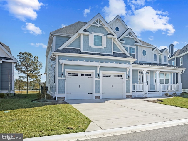 view of front of home featuring a garage, concrete driveway, a front lawn, roof with shingles, and covered porch