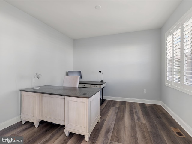 office area featuring baseboards, visible vents, and dark wood finished floors
