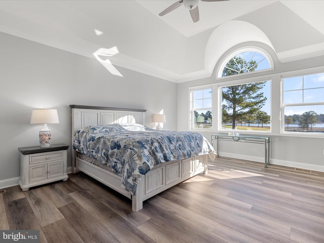 bedroom with baseboards, lofted ceiling, wood finished floors, and ceiling fan