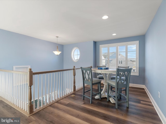 dining space with baseboards, dark wood-style floors, and recessed lighting