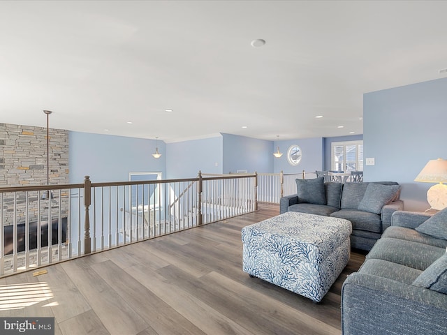 living area with wood finished floors and recessed lighting