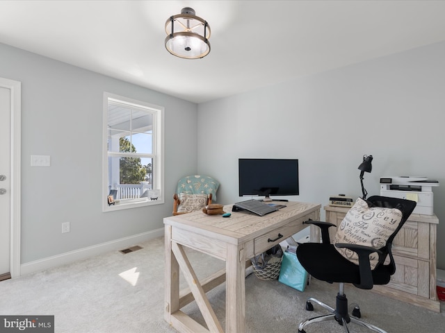 carpeted office with baseboards and visible vents