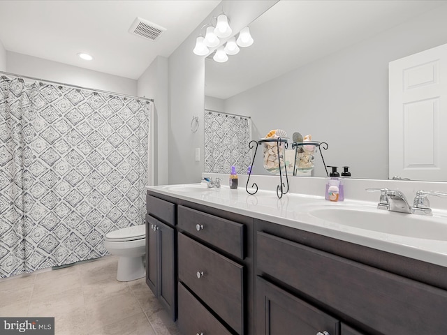 full bathroom featuring a sink, double vanity, visible vents, and toilet