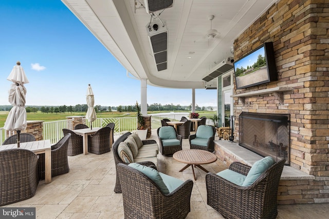 view of patio / terrace featuring an outdoor living space with a fireplace and outdoor dining space