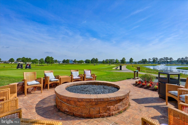 view of patio / terrace featuring an outdoor fire pit and a water view