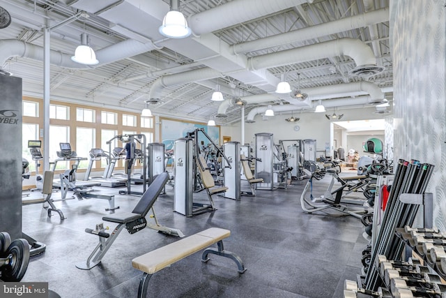gym with a towering ceiling