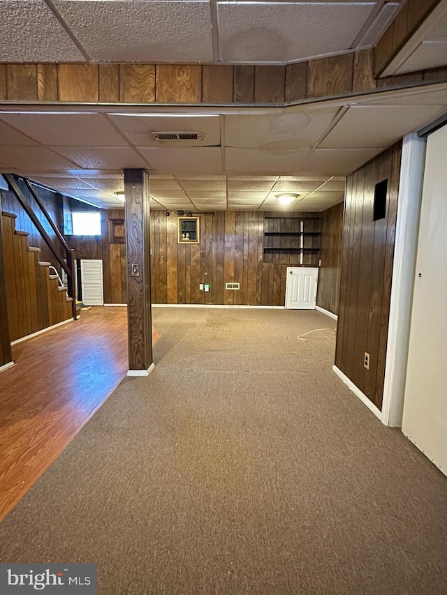 1224 Sheridan Ave, Baltimore, MD 21239 - below grade area with wood walls, a drop ceiling, and carpet