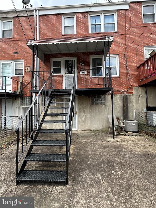 1224 Sheridan Ave, Baltimore, MD 21239 - exterior space with brick siding, fence, and cooling unit