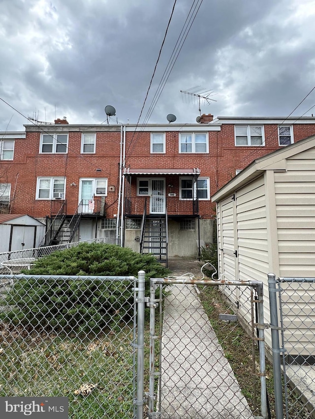 1224 Sheridan Ave, Baltimore, MD 21239 - back of house with a storage shed, a gate, fence private yard, and an outdoor structure