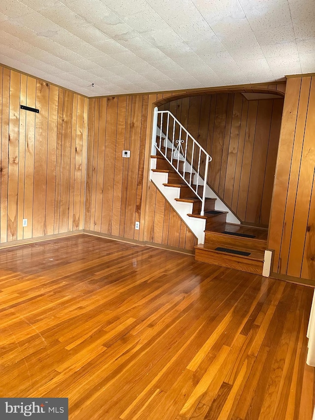 1224 Sheridan Ave, Baltimore, MD 21239 - basement with stairs, wood walls, and hardwood / wood-style flooring