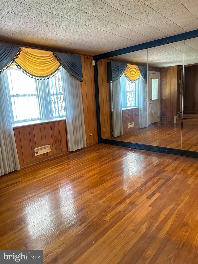 1224 Sheridan Ave, Baltimore, MD 21239 - spare room with wooden walls and hardwood / wood-style flooring