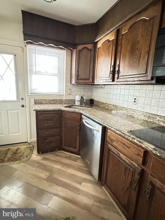 1224 Sheridan Ave, Baltimore, MD 21239 - kitchen with tasteful backsplash, black electric stovetop, dishwasher, light wood finished floors, and a sink