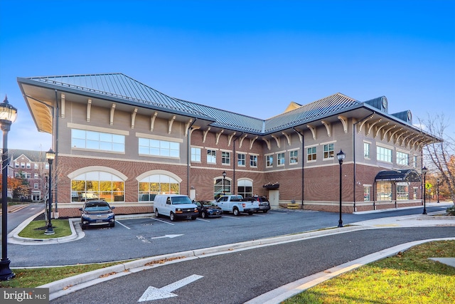 view of building exterior featuring uncovered parking