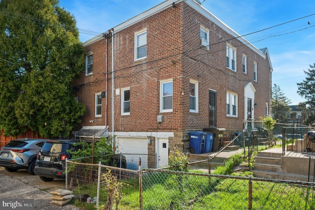 exterior space featuring a garage and fence