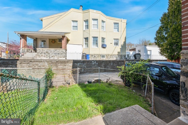 view of side of property featuring a porch and fence
