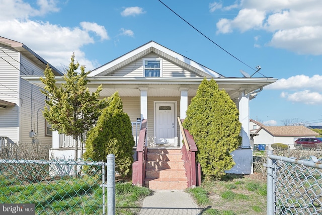 view of front of home with a porch and fence