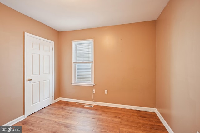 unfurnished bedroom featuring baseboards, light wood finished floors, and visible vents