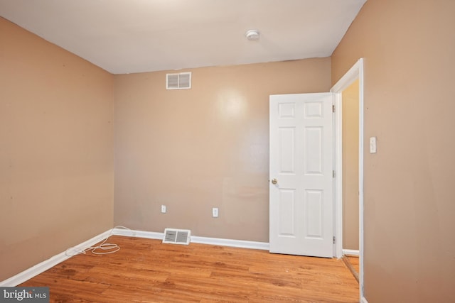 unfurnished room with light wood-style flooring, baseboards, and visible vents