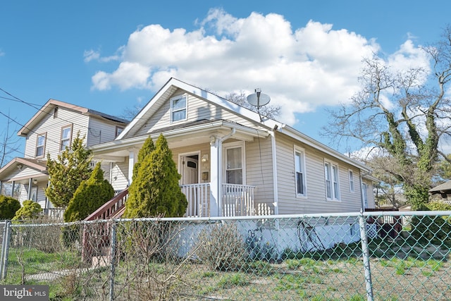 view of front facade featuring a fenced front yard and a porch